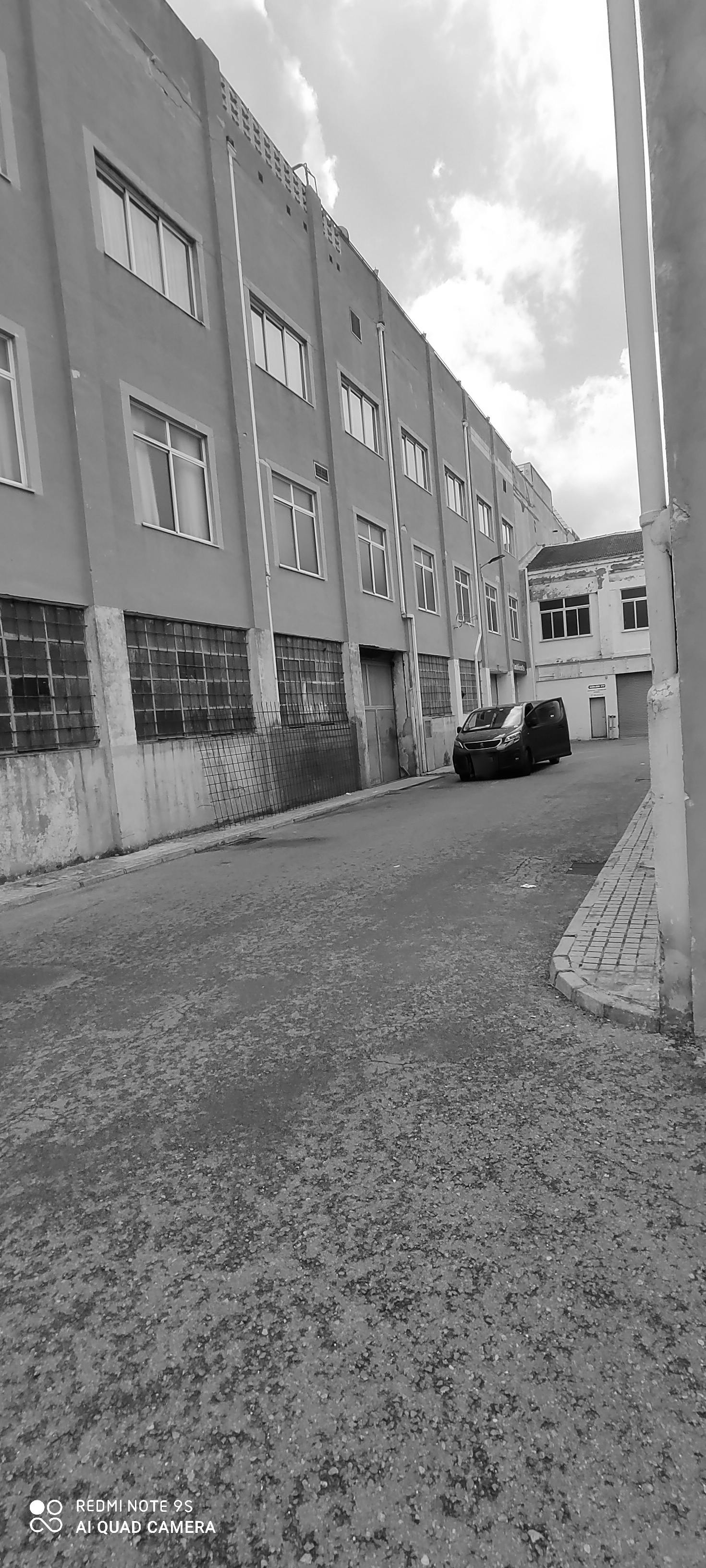 Solar panels on an urban rooftop with a modern city skyline in the background