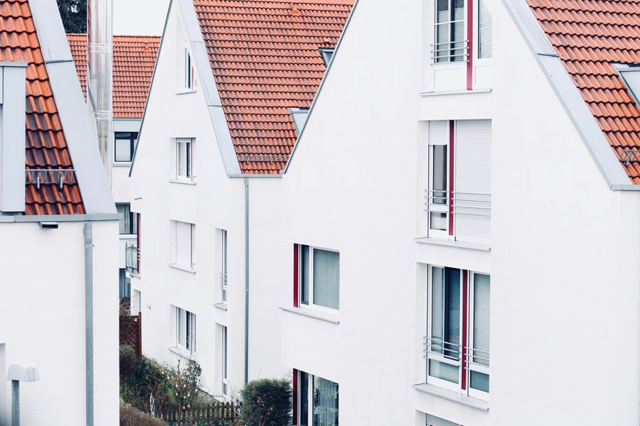 Modern suburban houses with red roofs