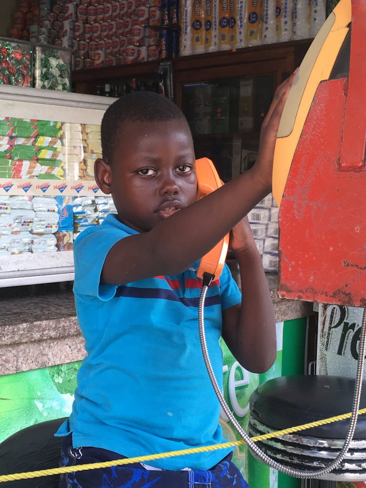 Boy Using Analog Telephone