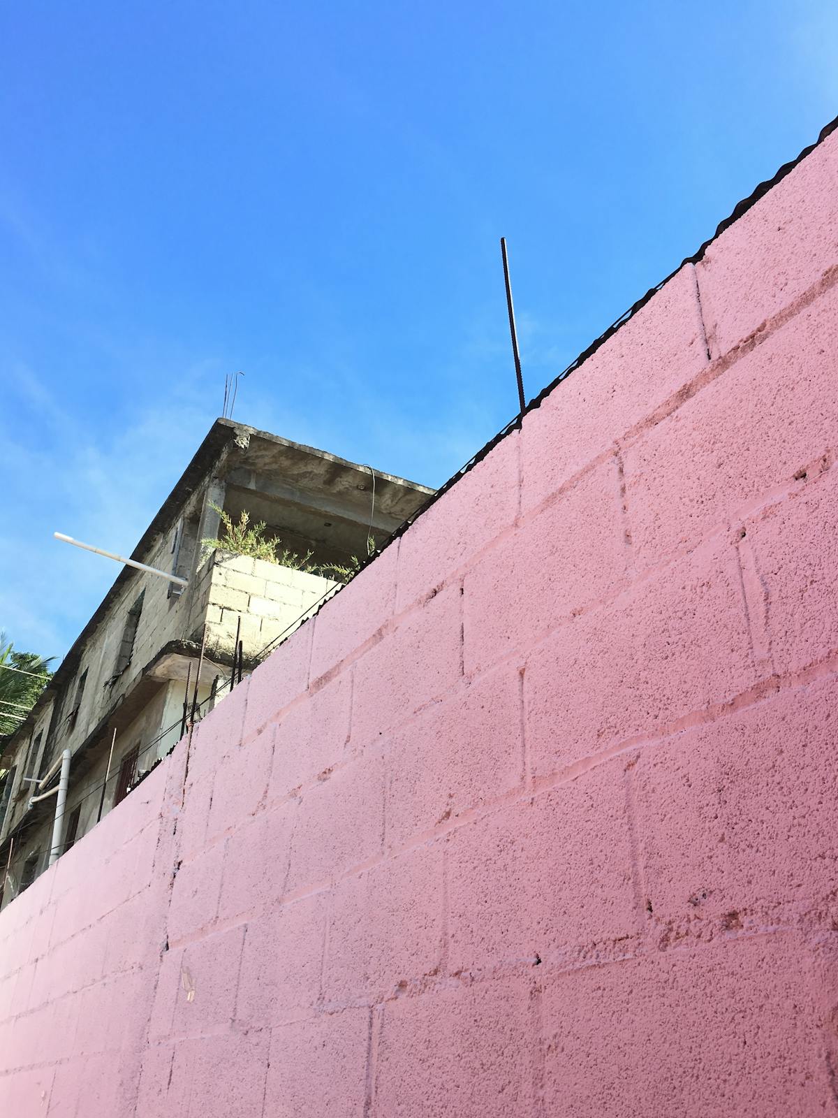 Rows of large solar panels under the sun with clouds in the background