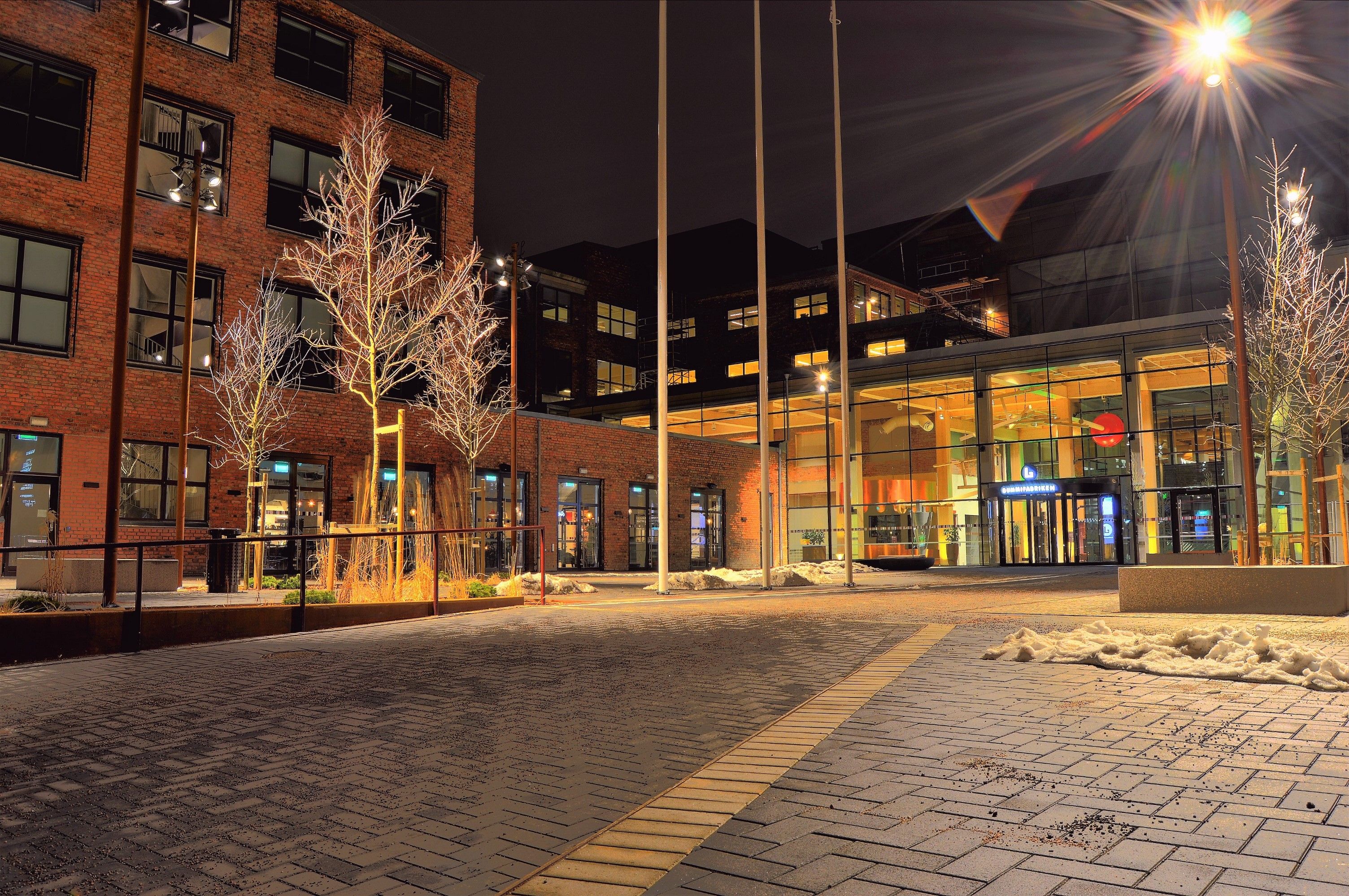 A modern architectural building illuminated at night, located in Sweden.