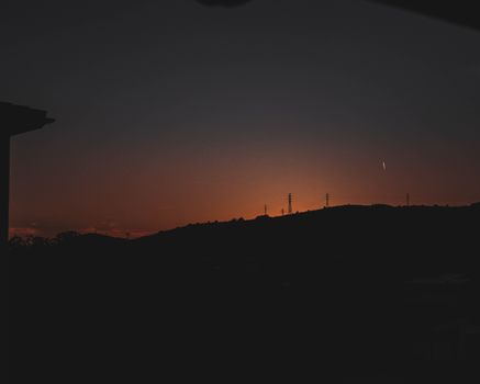 A captivating silhouette of hills at sunset, featuring a clear sky and scenic beauty in Barcelona.