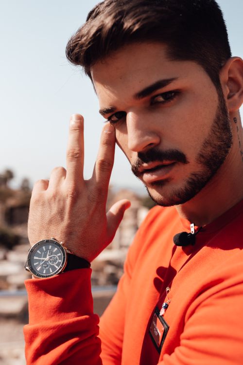 Free Fashionable young man with a beard wearing a wristwatch in a casual outdoor portrait. Stock Photo