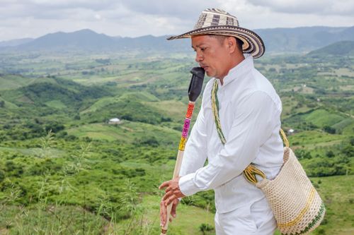 Free Musician playing flute on a hilltop in Ovejas, Colombia. Stock Photo