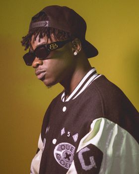Profile photo of young man in fashion-forward streetwear with cap and sunglasses.
