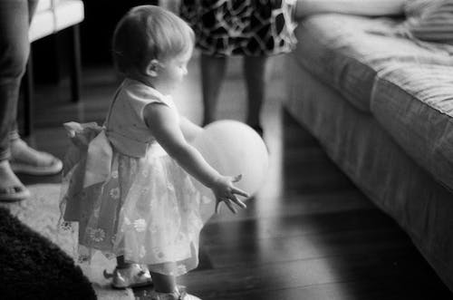 Free Grayscale Photo of Toddler Holding a Balloon Stock Photo