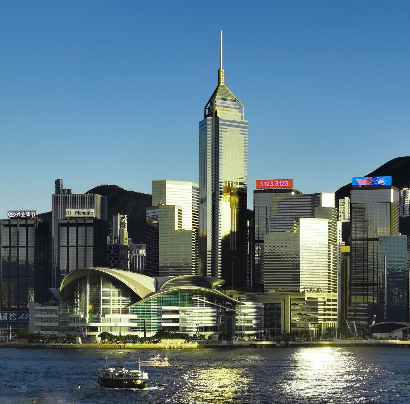 Stunning view of Hong Kong skyline with modern architecture and waterfront reflections at twilight.