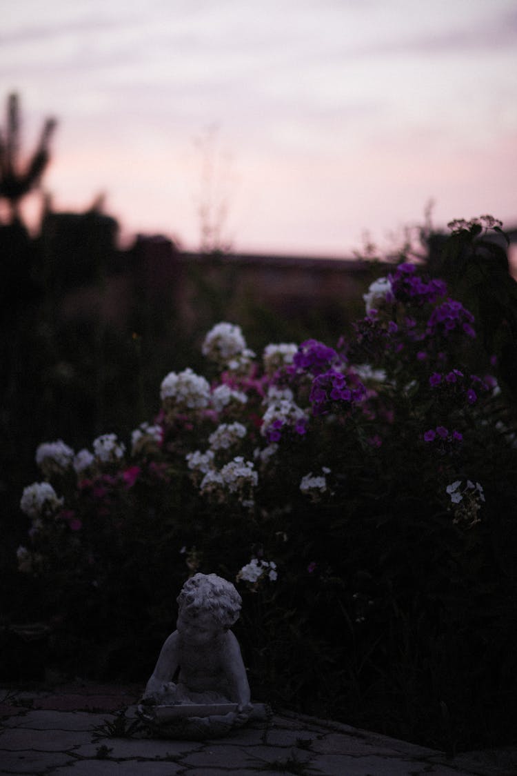 Figurine And Flowers