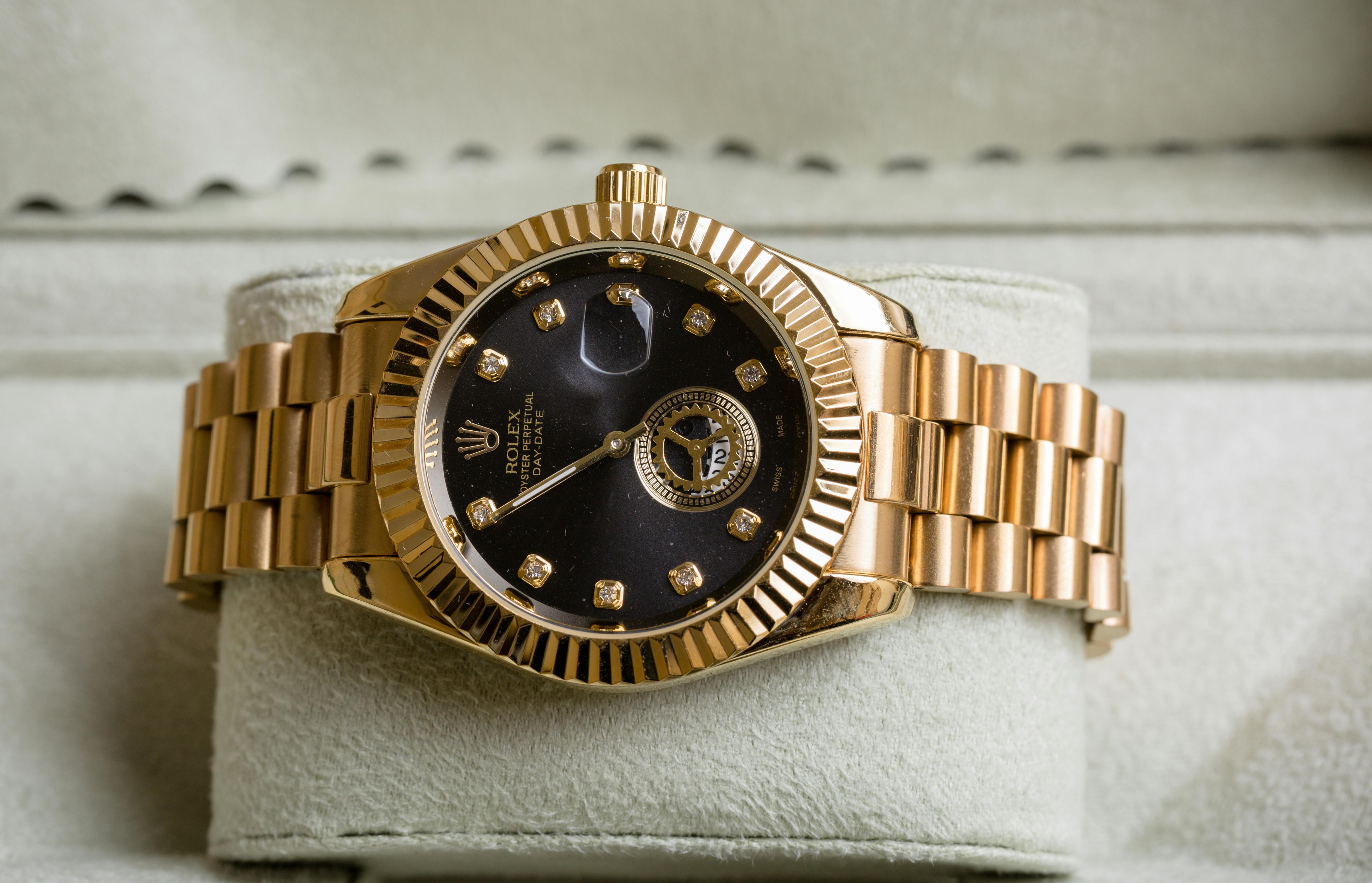 a rolex oyster perpetual gold wristwatch