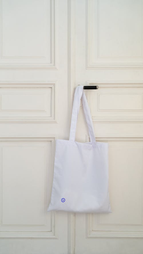 Free Bag Hanging on a Door handle Stock Photo