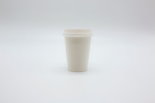 Paper Cup with Lid on White Surface