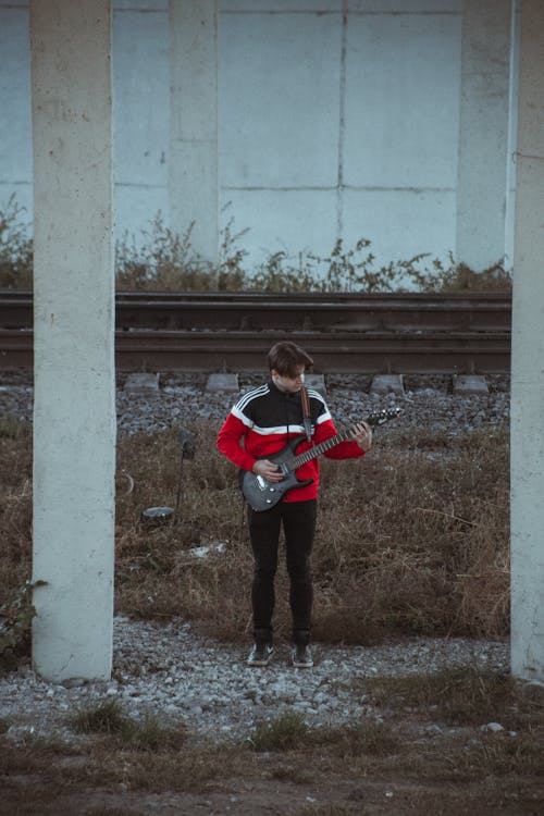  A Man Playing the Electric Guitar