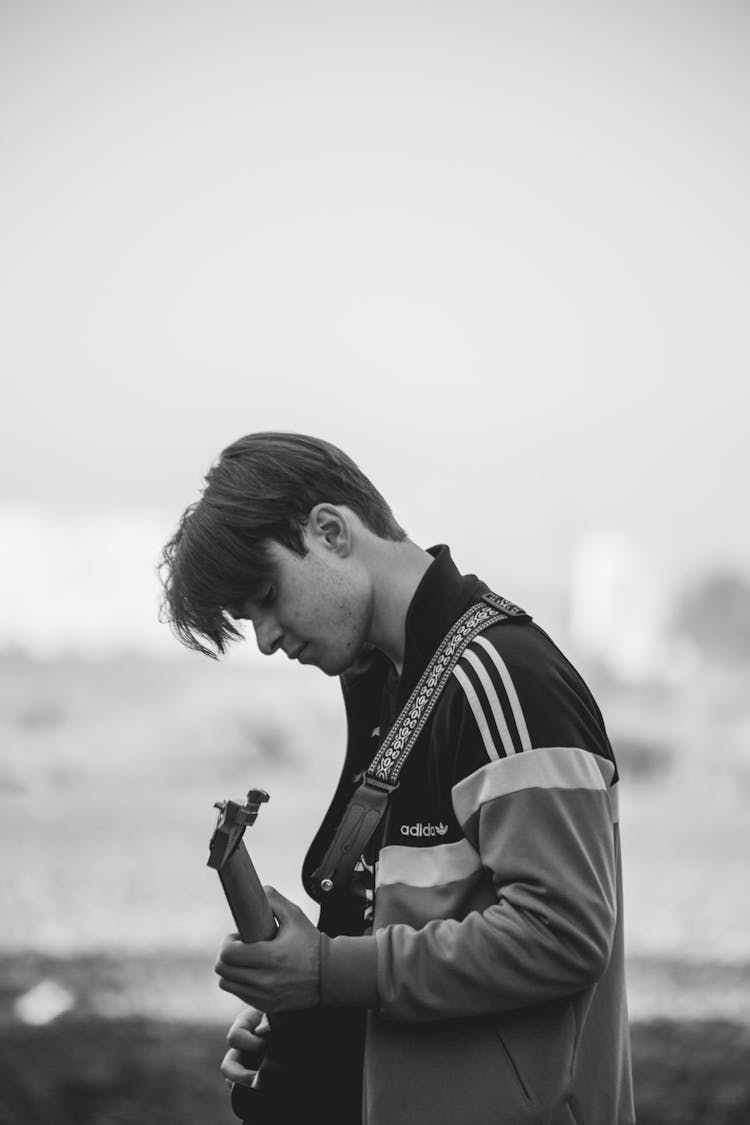 Black And White Portrait Of Man Playing On Guitar