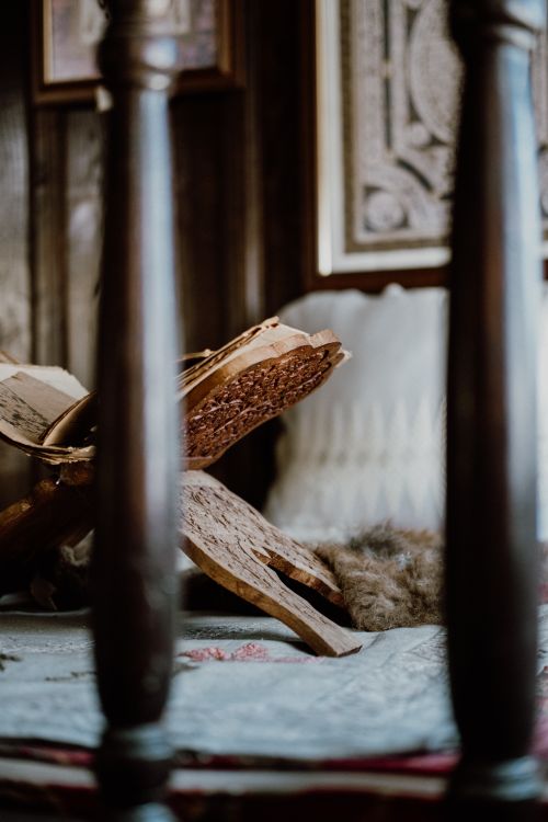 Free A wooden book stand displaying an open book, creating a rustic atmosphere in a cozy interior setting. Stock Photo