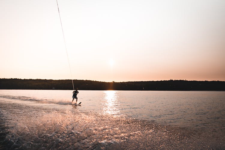 Man Water Skiing On Lake In Summer