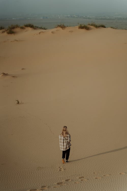 A Woman Walking in the Sand