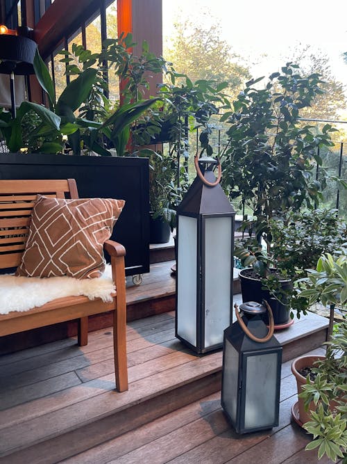 Metal Lanterns Beside  Potted Plants