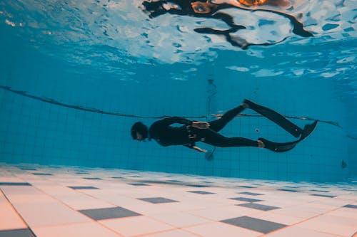 Man in Black Wet Suit Underwater