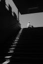 Black and White Portrait of Man on Top of the Stairs