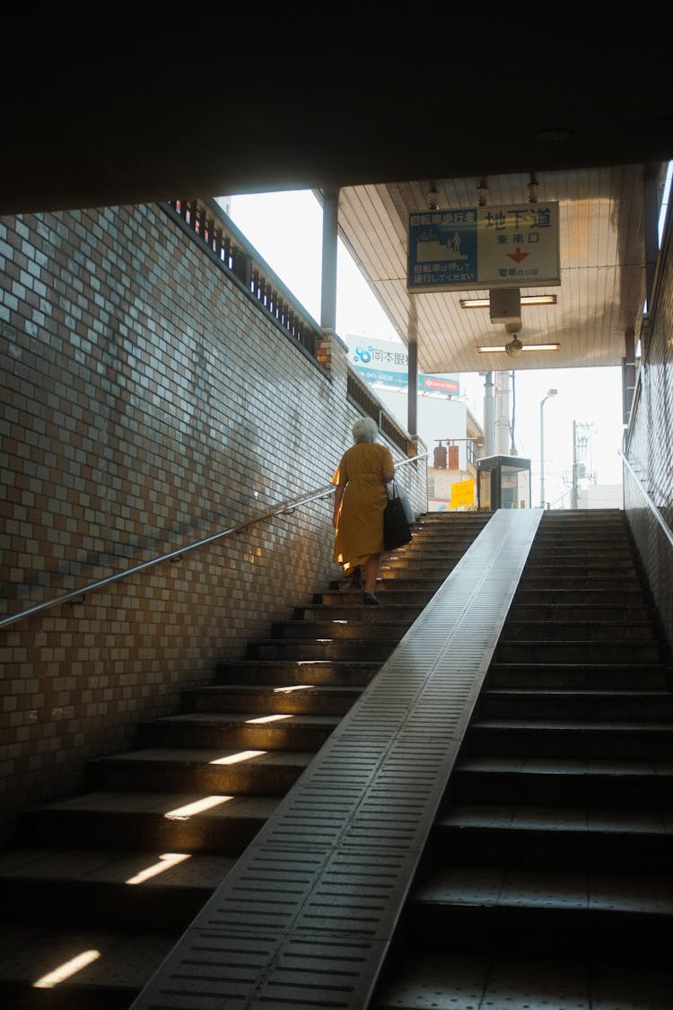 Woman Walking Up The Stairs