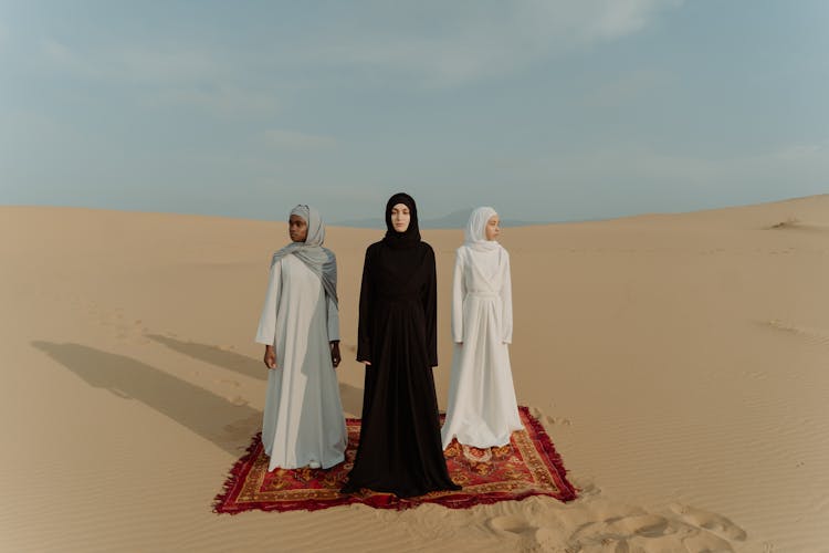 Women In Long Dresses Standing On The Desert