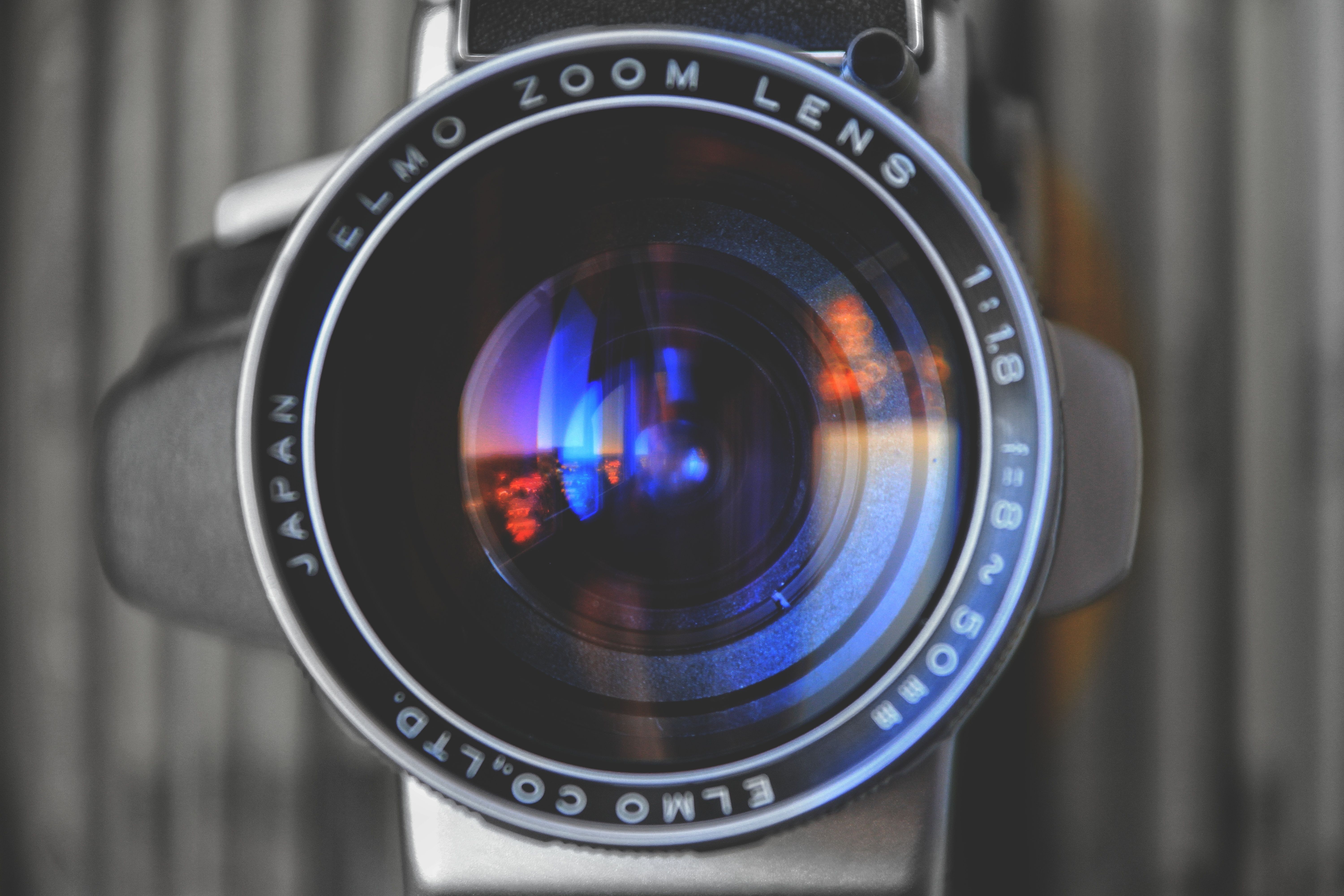 Artistic close-up shot of an ELMO zoom lens with blue reflections.