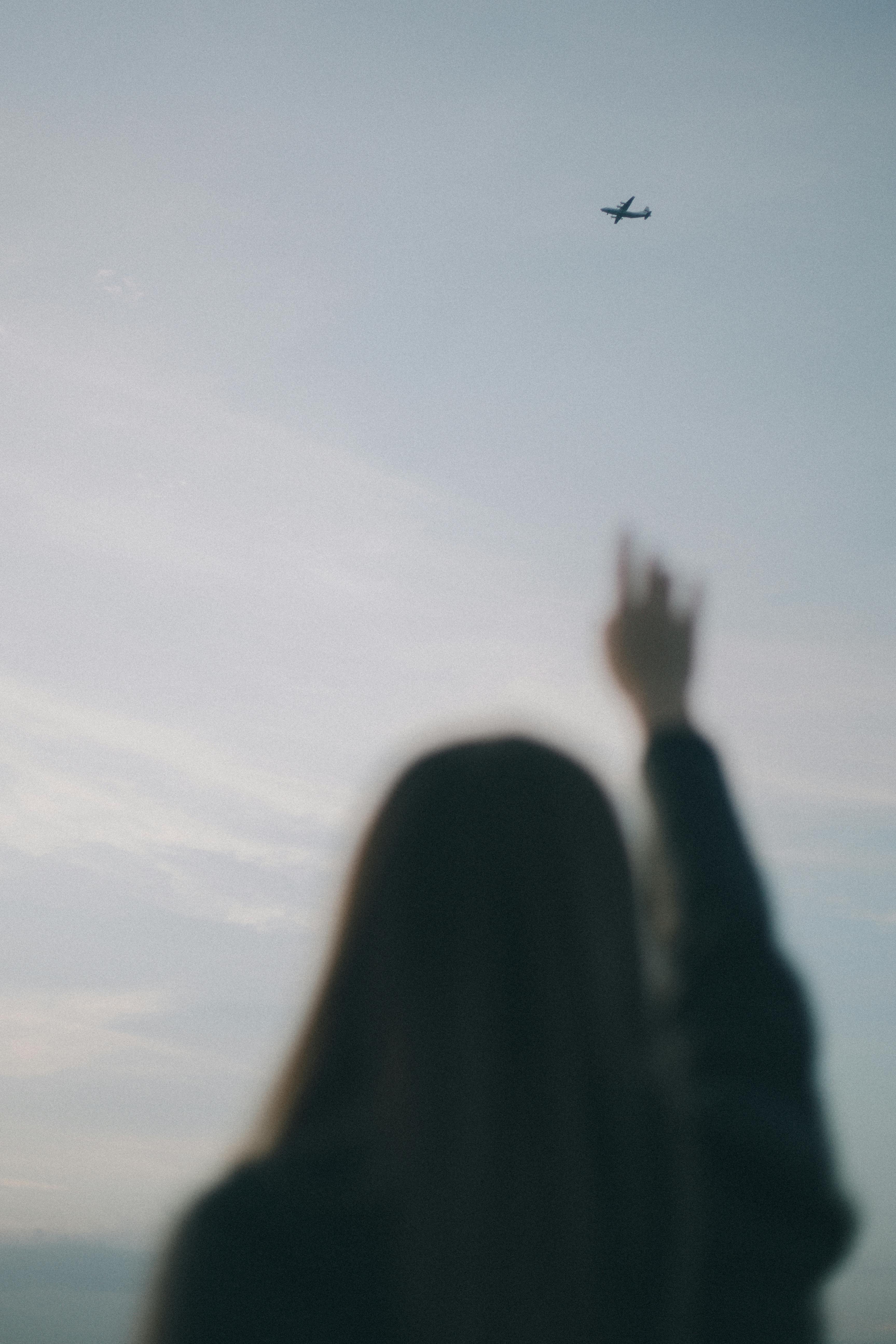 girl reaching up to the sky