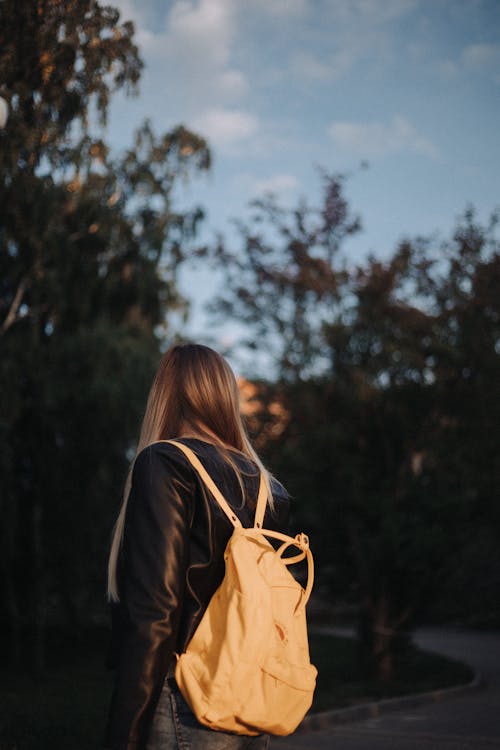 Woman in Black Jacket With Leather Backpack