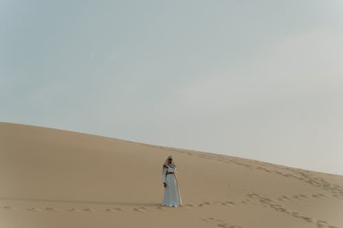 A Woman Standing on the Sand 