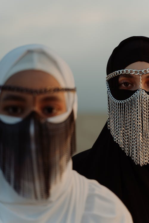 Two Women Wearing Chain Mask
