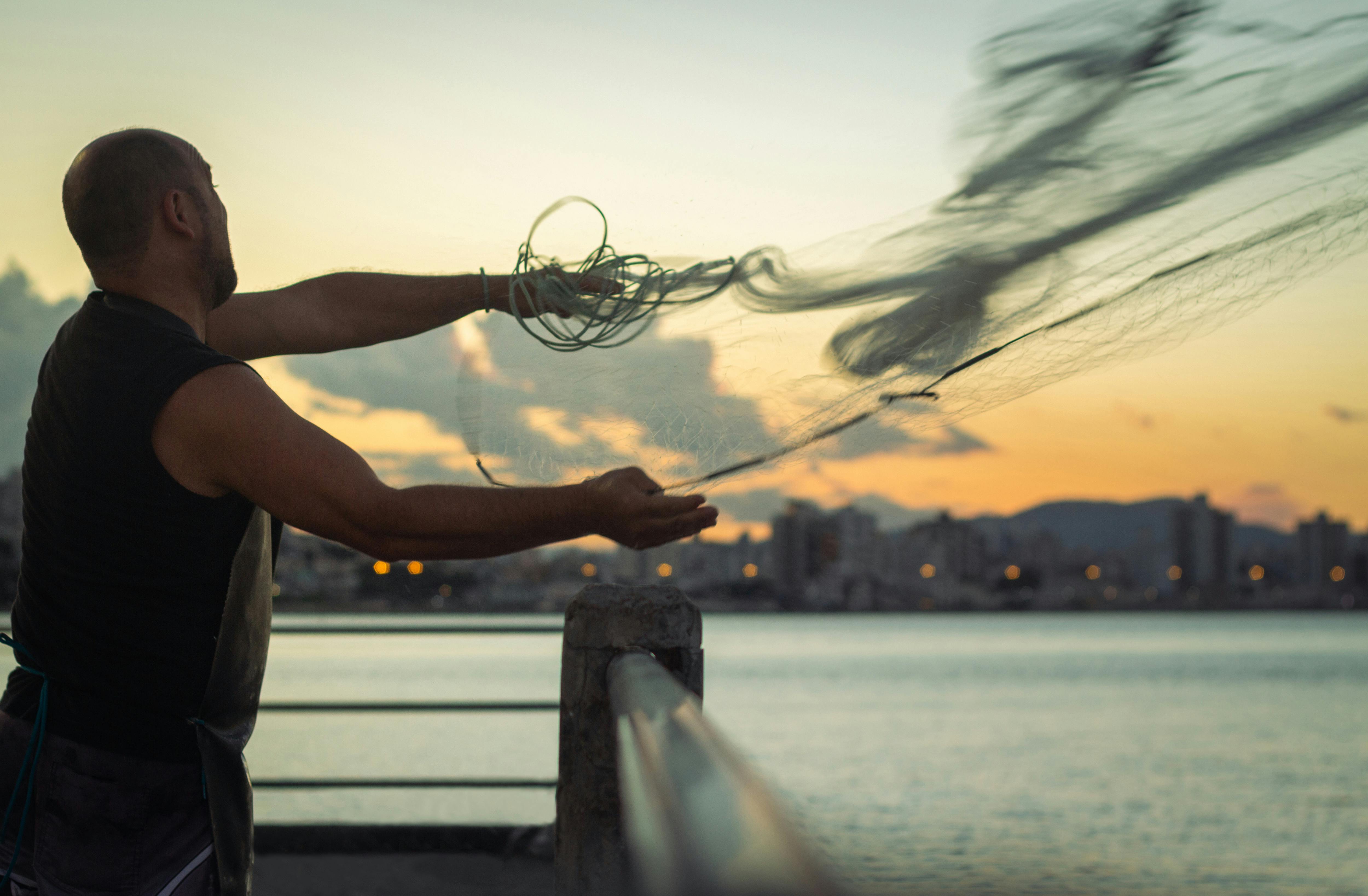 A Man Throwing Fish Net · Free Stock Photo