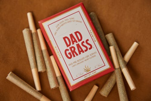 Free Rolled Joints on Brown Surface Stock Photo