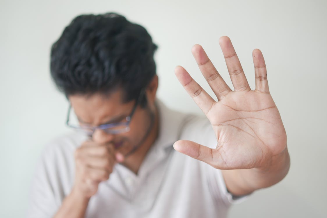 Photo of Allergy Reaction and Coughing Man's Hand