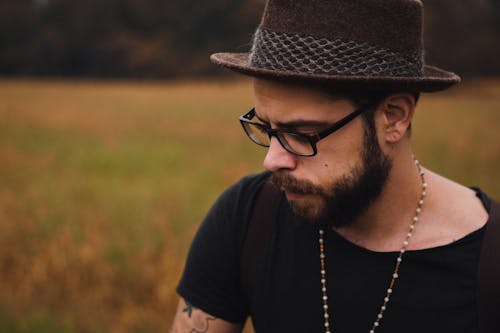 Free Portrait of a Man with Facial Hair Wearing a Brown Hat Stock Photo