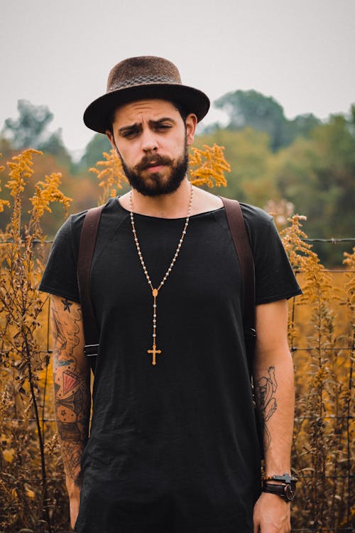 Tattooed Man Wearing a Brown Hat