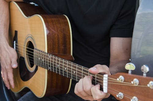 Free  A Person Playing an Acoustic Guitar  Stock Photo