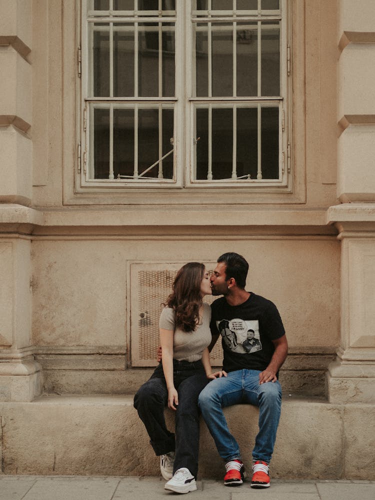 Couple Kissing Under Window