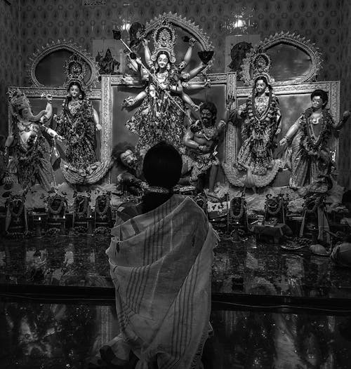 Grayscale Photo of a Person inside an Indian Temple