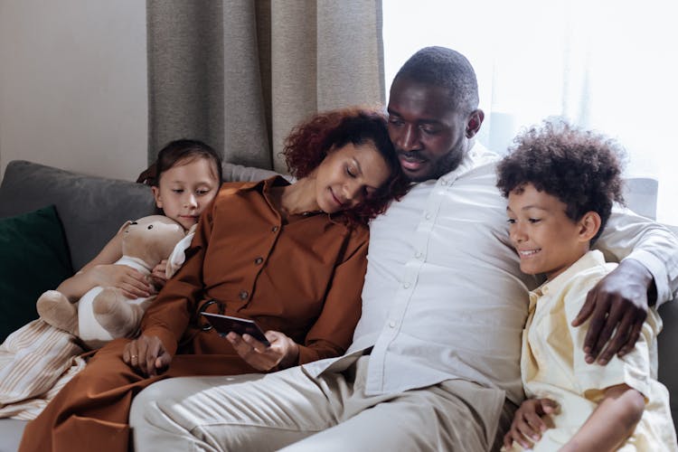 Family Sitting Together On Couch