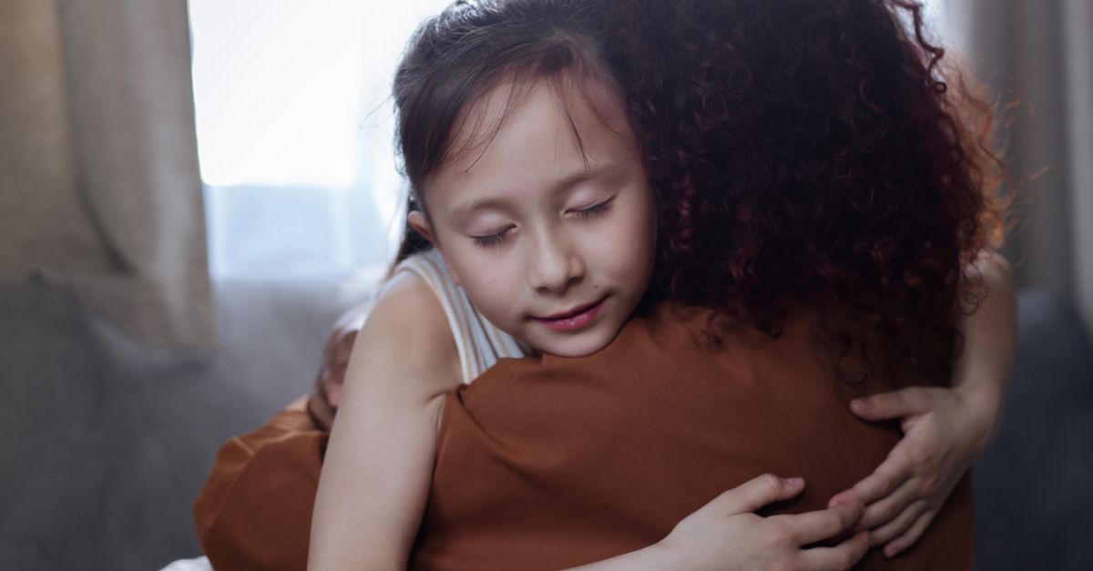 A heartfelt mother-daughter hug indoors, symbolizing love and connection.