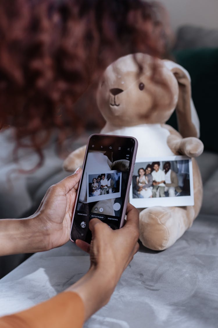 Close Up On Womans Hands Taking Picture Of Photograph