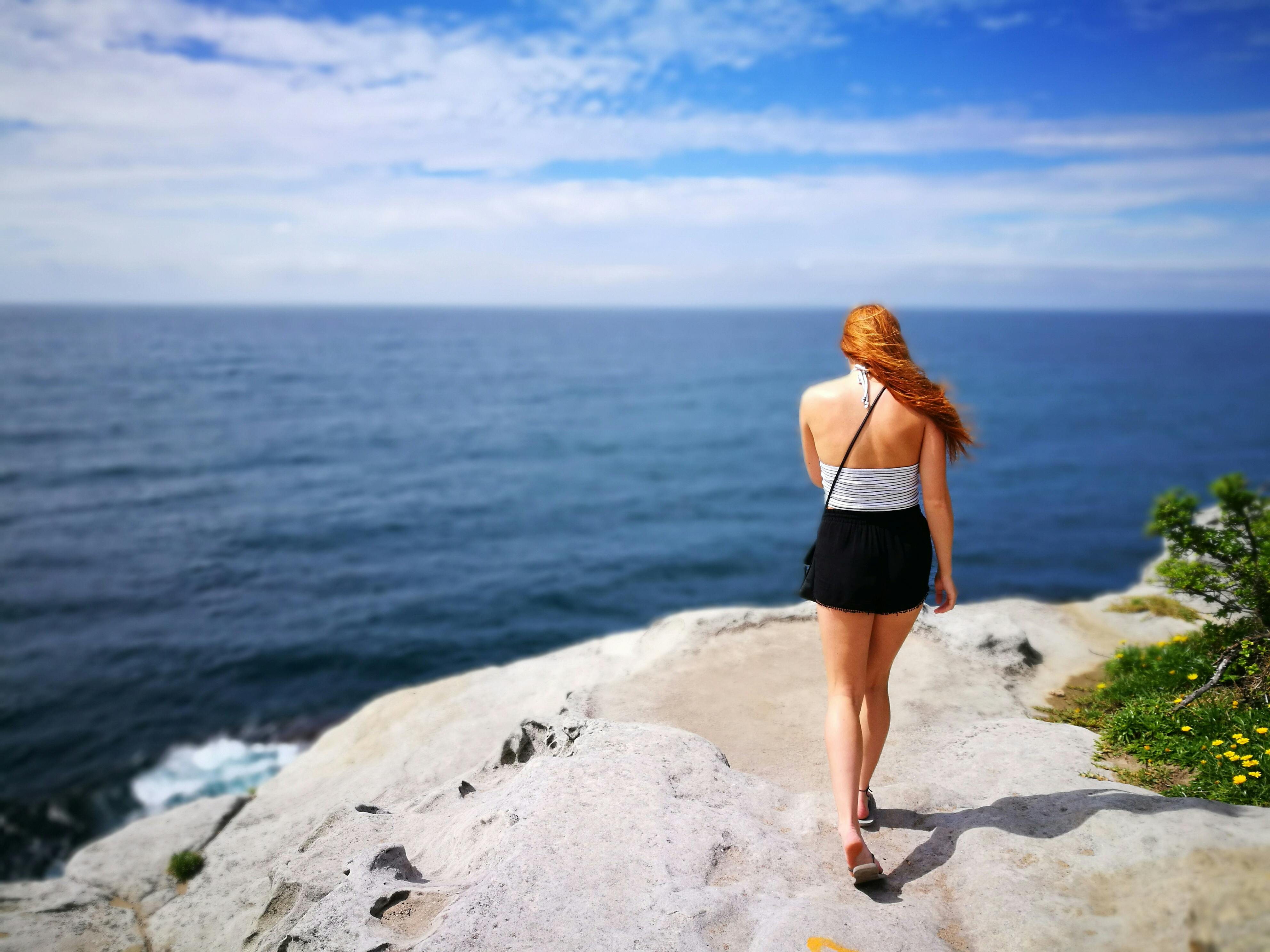 Woman Wearing Black Skirt Walking on Side of Cliff · Free Stock Photo