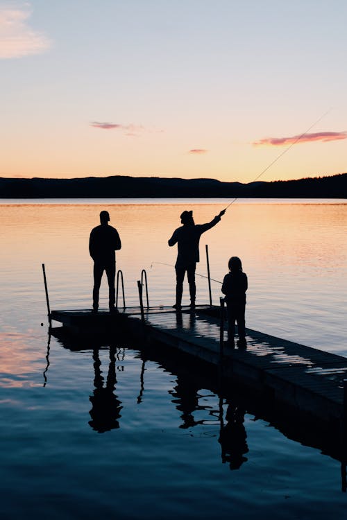 Free Three People on a Wooden Fishing Docks Stock Photo