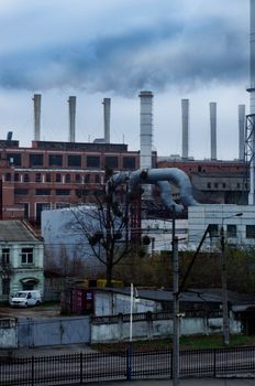 Factory complex with smokestacks emitting smoke, illustrating industrial pollution.