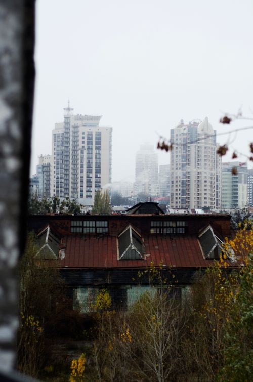 Free City skyline with tall buildings contrasted by an old warehouse in the foreground. Stock Photo