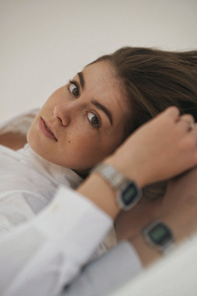 Woman In White Shirt Lying On Reflective Surface