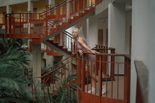 Young Woman in Fairy Outfit on Staircase