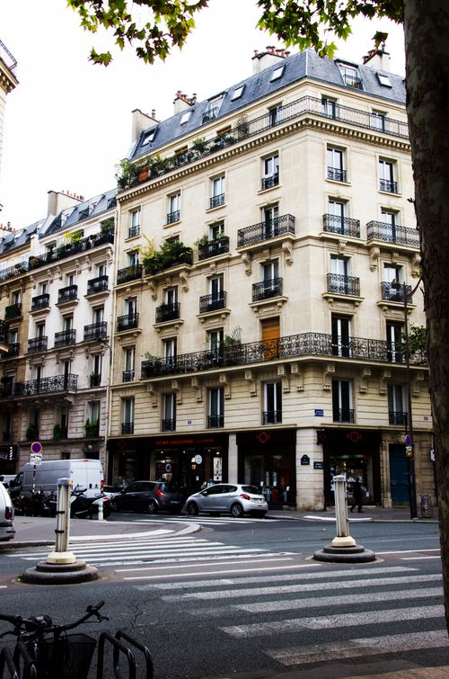 Free Elegant Parisian building with classic architecture on a busy street corner. Stock Photo