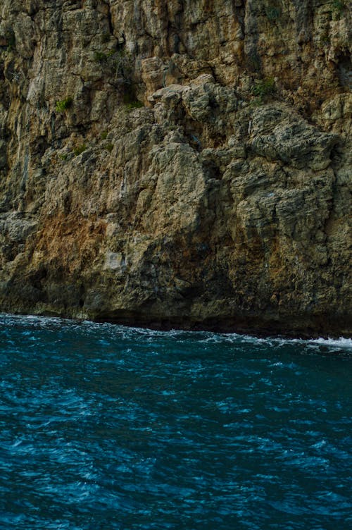 Photo of a Cliffside Near a Blue Ocean