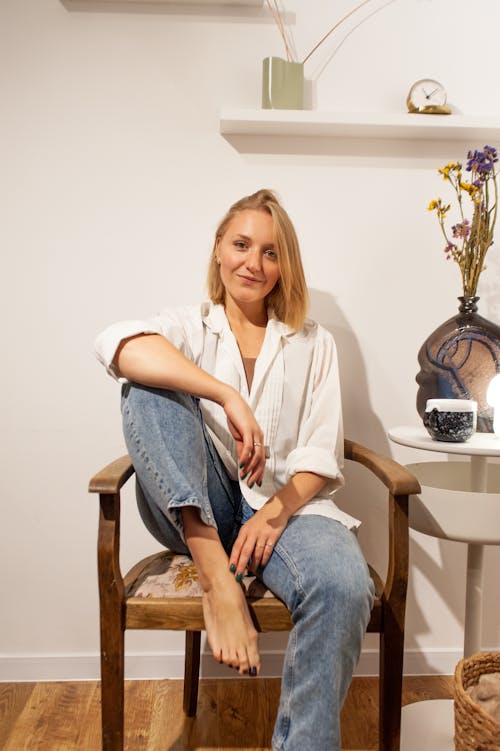 Smiling Woman with Blond Hair Sitting on Chair